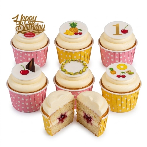 Collection of birthday cupcakes with white frosting, fruit, nut decorations, and custom age topper.