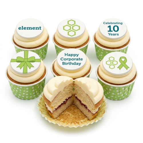 Set of six corporate cupcakes with custom logo, green bow, green ribbon, and celebration messages on white edible toppers with green polka dot cases.