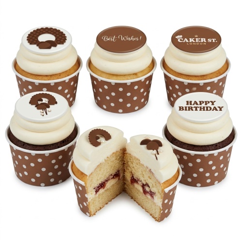 Assortment of elegant birthday cupcakes with cream frosting, chocolate toppers, and polka dot wrappers.