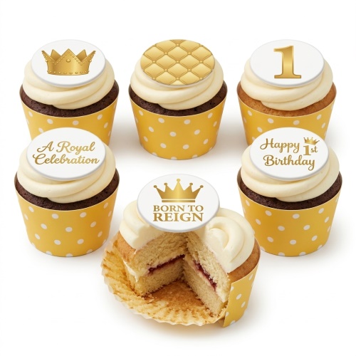 Six cupcakes with white buttercream and gold royal crown, quilted, and '1st Birthday' toppers on yellow polka dot wrappers, one cut open to show jam filling.