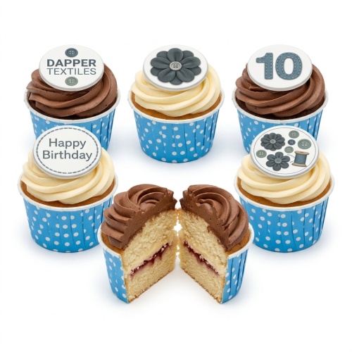 Assorted sewing theme birthday cupcakes with button, flower, thread spool, and custom age toppers.