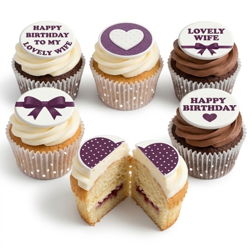 Assorted birthday cupcakes with white frosting, purple heart and bow toppers, and birthday messages.