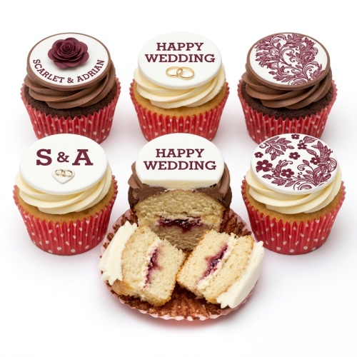 Wedding cupcakes with white and brown frosting, edible rings, maroon rose, and floral patterns.