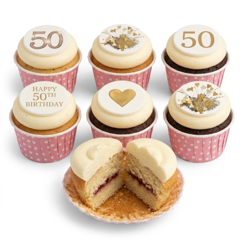 White and gold cupcakes with heart and custom age toppers in pink polka dot cases.