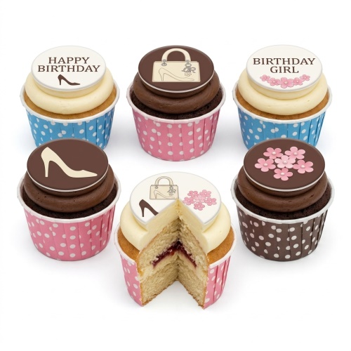Assortment of birthday cupcakes with high heel, handbag, and flower toppers, some with 'Happy Birthday' message.