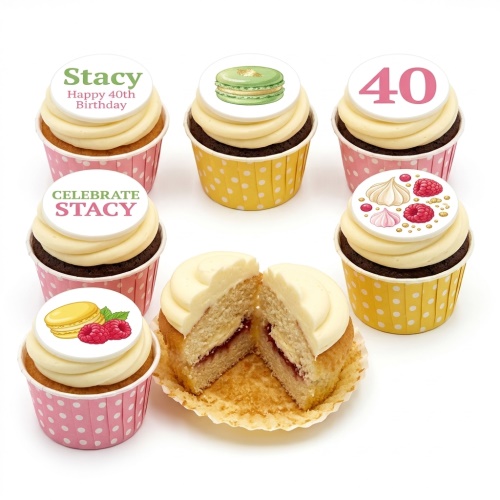 Cupcakes with white frosting, edible toppers featuring macarons, raspberries, meringues, and custom birthday messages.
