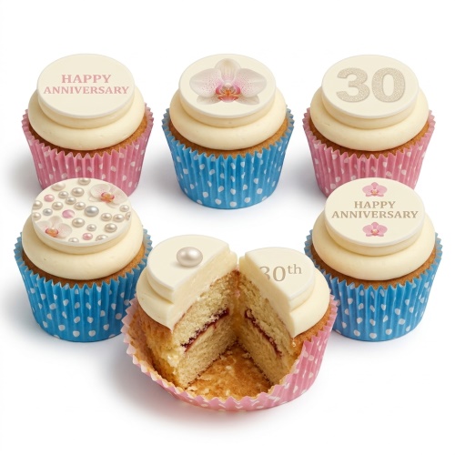 Vanilla cupcakes with white frosting, decorated with pearl clusters, pink orchids, and custom anniversary messages.
