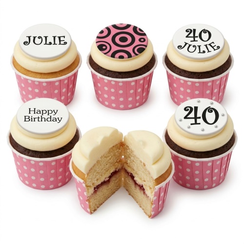 Pink polka dot birthday cupcakes with cream frosting and custom age and name toppers.