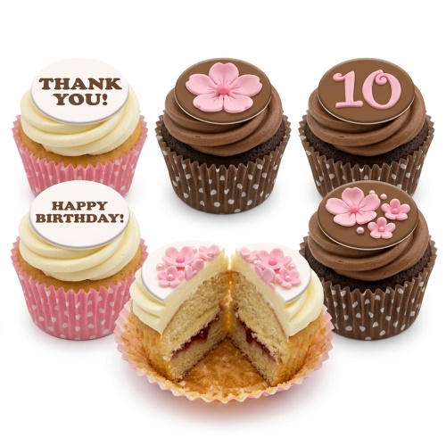 Assortment of floral birthday cupcakes with pink sugar flowers, custom age and message toppers.