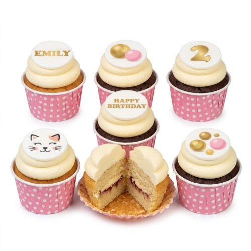 Girls birthday cupcakes with white frosting, pink polka dot cases, cat face, custom name and age toppers.