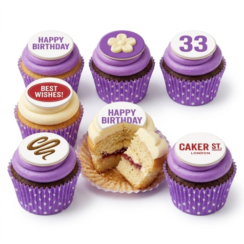A collection of purple and white birthday cupcakes with custom age topper, flower, swirl, and 'Happy Birthday' messages.