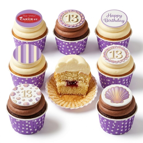 Assortment of mermaid and seashell themed birthday cupcakes with custom age and Happy Birthday toppers.