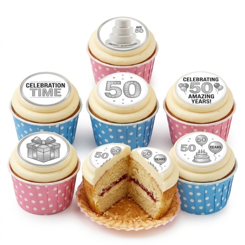 Cupcakes with white frosting and silver 50th birthday toppers, in pink and blue polka dot wrappers.