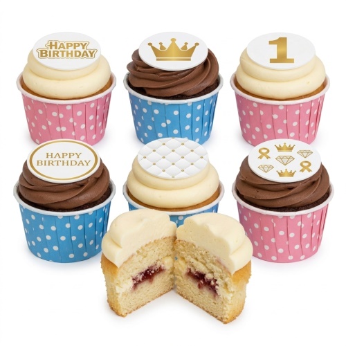 Assortment of kids birthday cupcakes with white and chocolate frosting, topped with gold crowns, "Happy Birthday" messages, and a custom age '1' topper, in pink and blue polka dot wrappers.