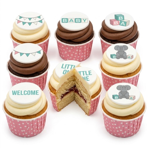 Baby shower cupcakes with white and chocolate frosting, decorated with elephant, baby block, and bunting toppers.