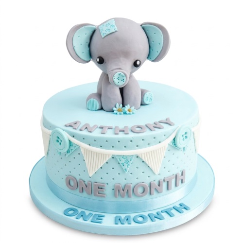 Two-tier light blue cake with a grey baby elephant topper, bunting, and custom name.