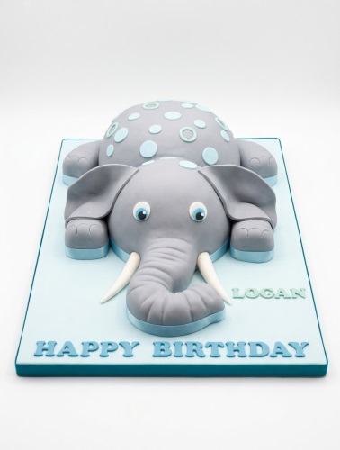 3D grey elephant birthday cake with light blue polka dots and a custom message.