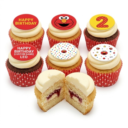 A selection of Elmo themed birthday cupcakes with red and yellow toppers, some with Elmo's face and polka dots, and one with a number 2.