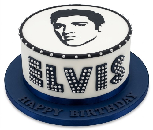 Round white cake with black Elvis Presley silhouette, 'ELVIS' in studded letters, and a navy blue base.