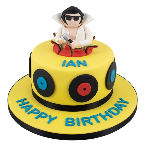 Yellow birthday cake with an Elvis Presley figure topper and vinyl record decorations.