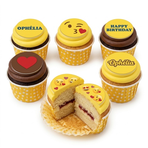 Yellow and brown cupcakes with emoji, heart, and 'Happy Birthday' toppers in polka dot cases.