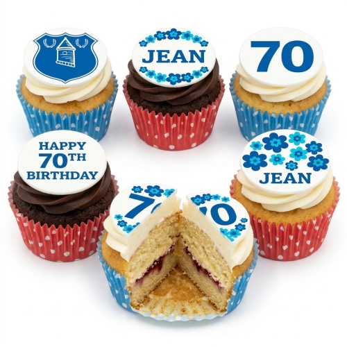 Selection of blue floral birthday cupcakes with custom age and name toppers, some with a shield emblem.