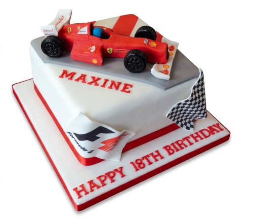 White square cake with a red Formula One racing car, track, and checkered flag. Personalised with name and age.