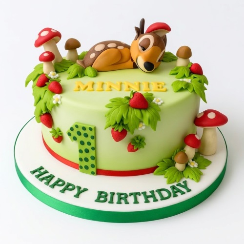 Light green round cake with fondant deer, red mushrooms, green leaves, and strawberries, with a custom age topper.