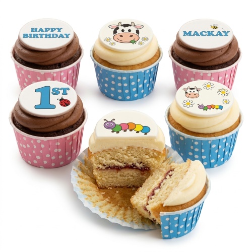 Kids birthday cupcakes with cute animal, caterpillar, and ladybug toppers in pink and blue cases.