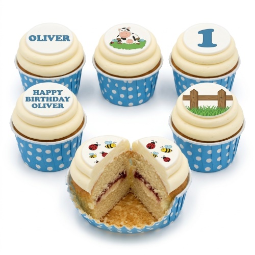 Cupcakes with white frosting and blue polka dot cases, topped with a cartoon cow, a wooden fence, ladybugs, and bees.