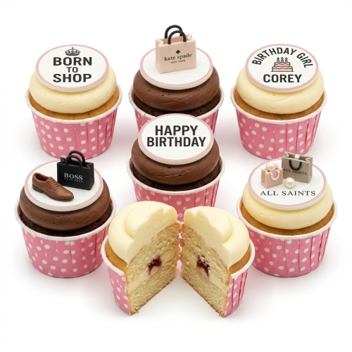 Fashion-themed birthday cupcakes with designer brand inspired shopping bag toppers and a brown shoe decoration.