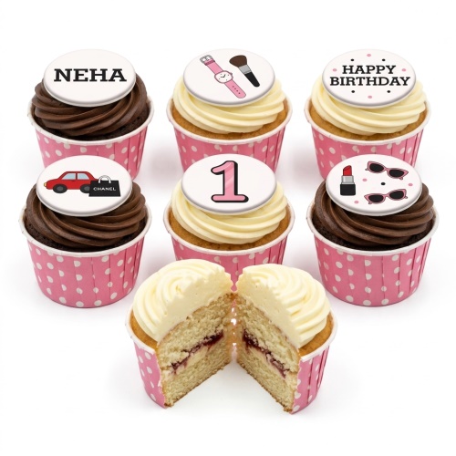 Birthday cupcakes with fashion and glamour themed edible toppers, including a watch, lipstick, sunglasses, car, and shopping bag.