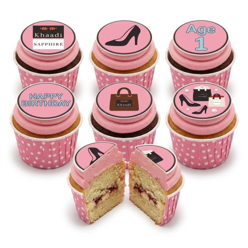 Pink cupcakes with fashion-themed toppers including high heels, shopping bags, and a 'Happy Birthday' message.