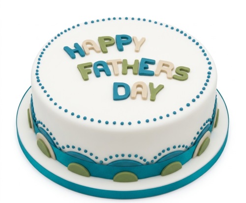 Round white Fathers Day cake with blue, green, beige lettering and teal ribbon.
