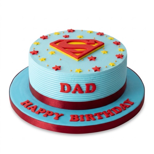 Round blue Superman themed birthday cake with red and yellow logo and stars, red ribbon, and custom message.