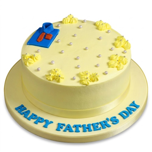 Round pale yellow cake with a blue shirt and orange tie decoration, white pearls, and yellow piped swirls, with "Happy Father's Day" written on the board.