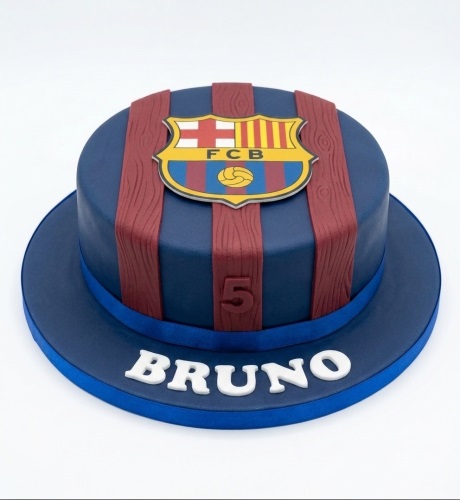 Round blue and red FC Barcelona football birthday cake with club crest and custom age topper.