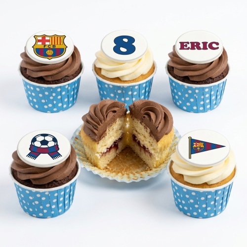 A set of FC Barcelona themed football cupcakes with chocolate and vanilla frosting, featuring club crests, a football with a scarf, a pennant, a custom age topper, and a personalised name topper.