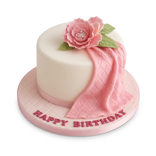Elegant round white birthday cake with pink sugar flower, draped pink quilted fondant, and 'Happy Birthday' message on the board.