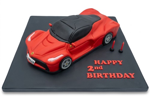 Red Ferrari sports car birthday cake with black roof and custom message.