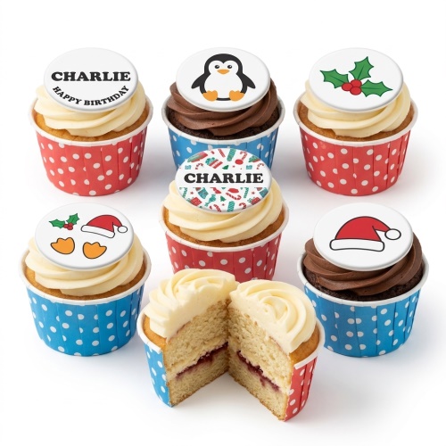 A selection of festive Christmas cupcakes with white and brown frosting, topped with edible decorations including a penguin, holly, Santa hat, and a personalised Christmas pattern.