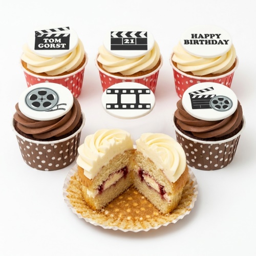 Film theme cupcakes with clapperboard, film reel, and film strip toppers. Some cupcakes have vanilla frosting, some chocolate.