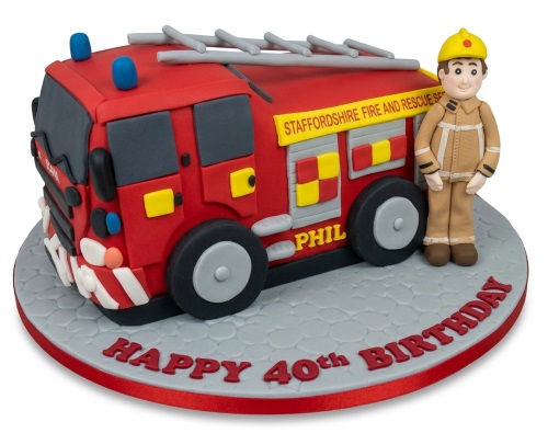 Red fire engine birthday cake with a firefighter figure and custom age message.