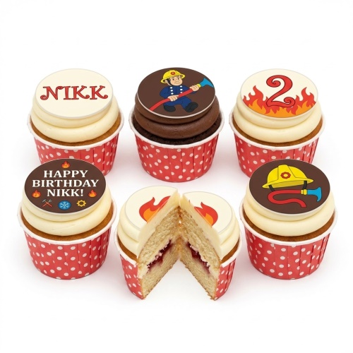 Firefighter themed birthday cupcakes with edible toppers, flames, helmet, and hose, in red polka dot wrappers.