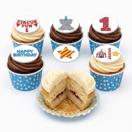 Circus themed cupcakes with elephant, star, circus tent, and "Happy Birthday" toppers on blue polka dot wrappers.