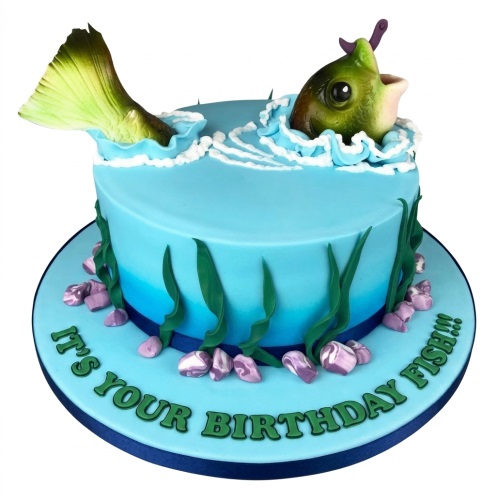 Round blue fishing theme birthday cake with 3D fish jumping from water and edible seaweed.