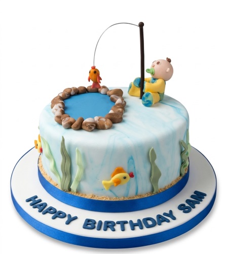Round blue and white marbled cake with a baby fishing figure, pond, fish, and seaweed decorations.