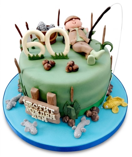 Round green fishing theme birthday cake with fisherman, fish, reeds, and a custom age topper.