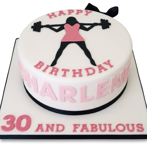 White round gym birthday cake with woman lifting barbell, pink and black details.