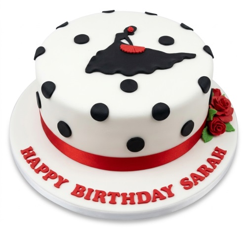 Two-tier white fondant cake with black polka dots, a black flamenco dancer silhouette, red fan, red roses, and a red ribbon.